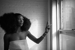 A model celebrating the slogan 'Black is Beautiful', Harlem, NYC (1968); c/o Magnum Photos